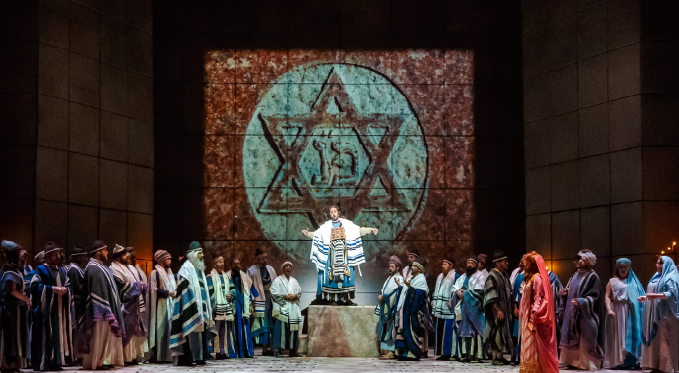 The high priest Zaccaria (Oren Gradus) leads the Israelites (Pittsburgh Opera Chorus and Supernumeraries) in prayer for protection from Nabucco. 