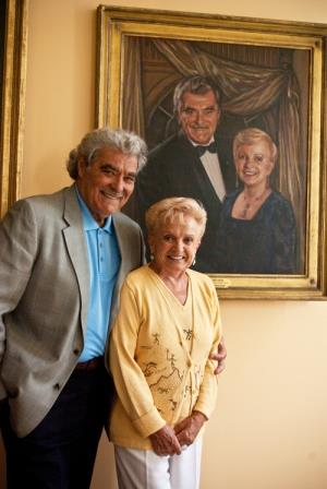 Tito and Gigi Capobianco in front of their portrait at Pittsburgh Opera Headquarters